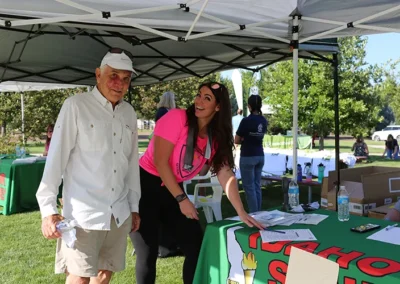 Volunteers assisting at outdoor registration table