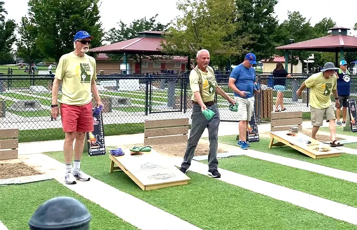 Senior men playing cornhole outdoors at park