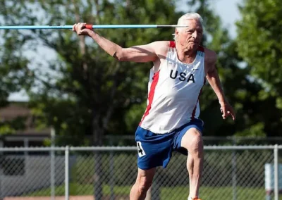 Senior athlete throwing javelin during track event