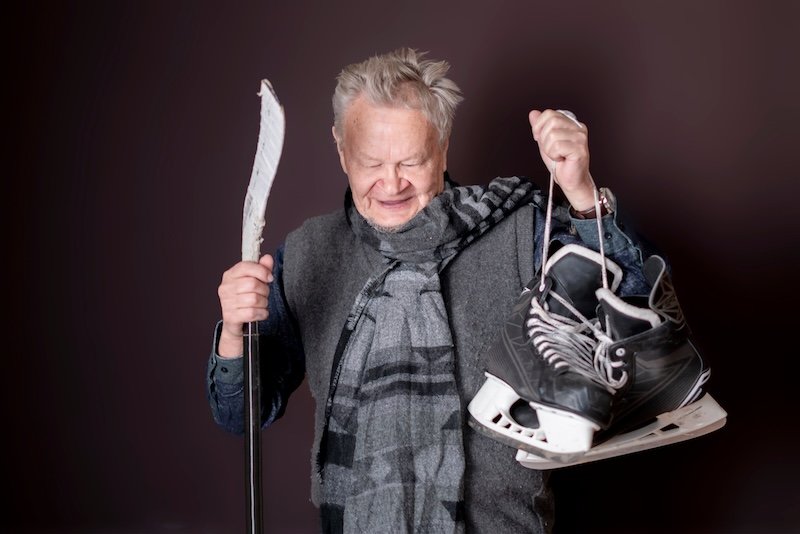 old senior sporty male with hockey equipment