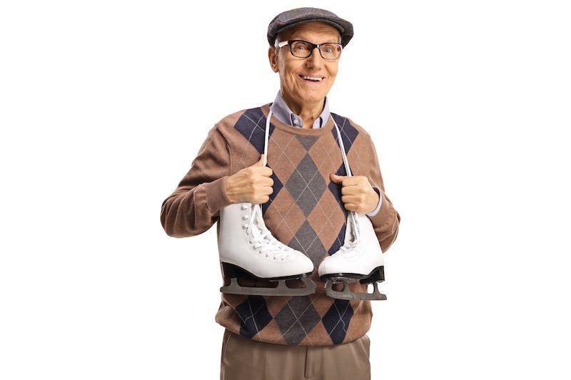 Elderly man with ice skates hanging around his neck isolated on white background